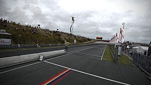 Dynamic Racing Scene: Cars Speeding on Zandvoort Circuit in Assetto Corsa Competizione under Cloudy Skies