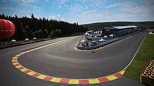 Daylight Racing Elegance: Cars Speeding on Spa-Francorchamps Circuit, Iconic Curve in the Foreground