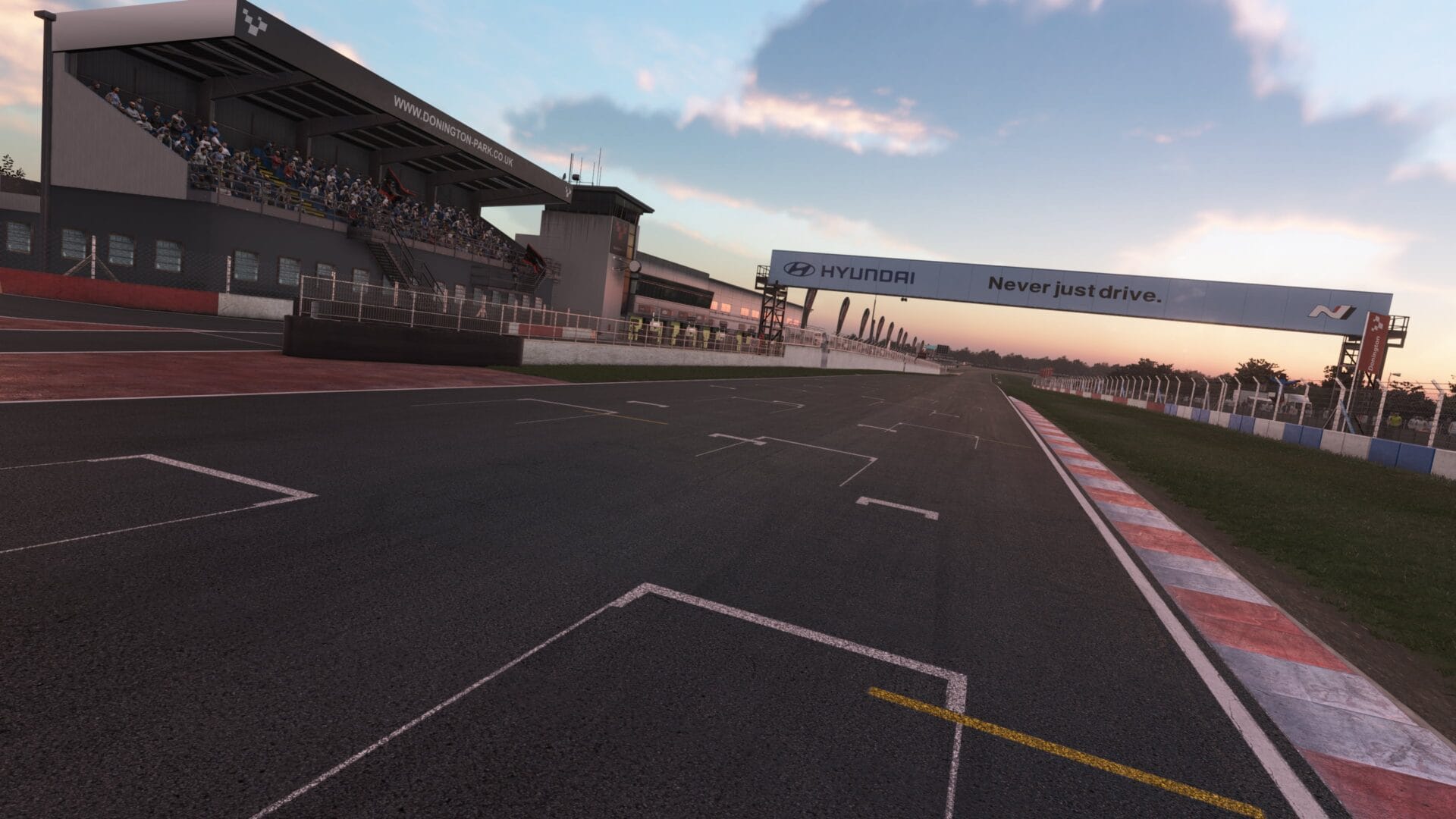 Sunset view of Donington Park in Assetto Corsa EVO Release 0.2, featuring the Hyundai “Never Just Drive” sign trackside.