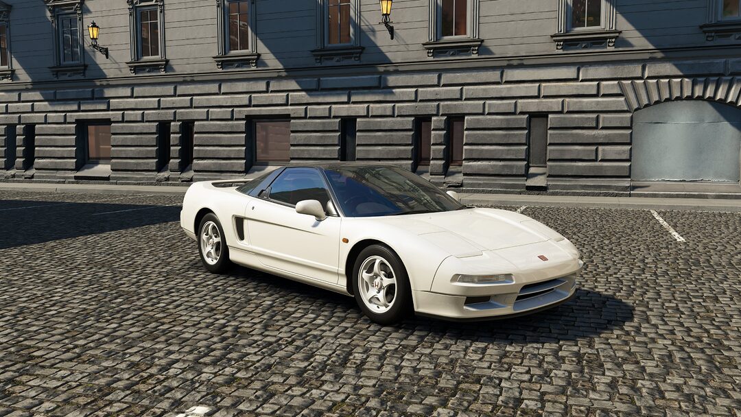 A white Honda NSX-R in a city backdrop, part of Assetto Corsa EVO Release 0.2. This lightweight, driver-focused variant was fine-tuned with Ayrton Senna’s input, offering an unfiltered purist driving experience.