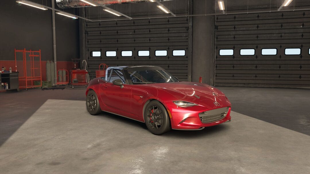 Mazda MX5 ND Global Cup 2017 race car (from EA AC EVO car list) positioned in a garage near a racetrack, with racing gear and tools visible in Assetto Corsa EVO.